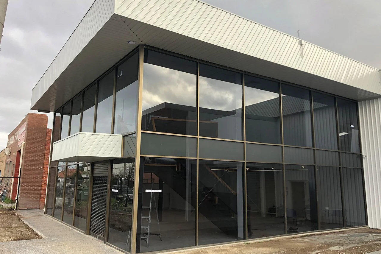 Large commercial building featuring full-height glass walls in Altona North