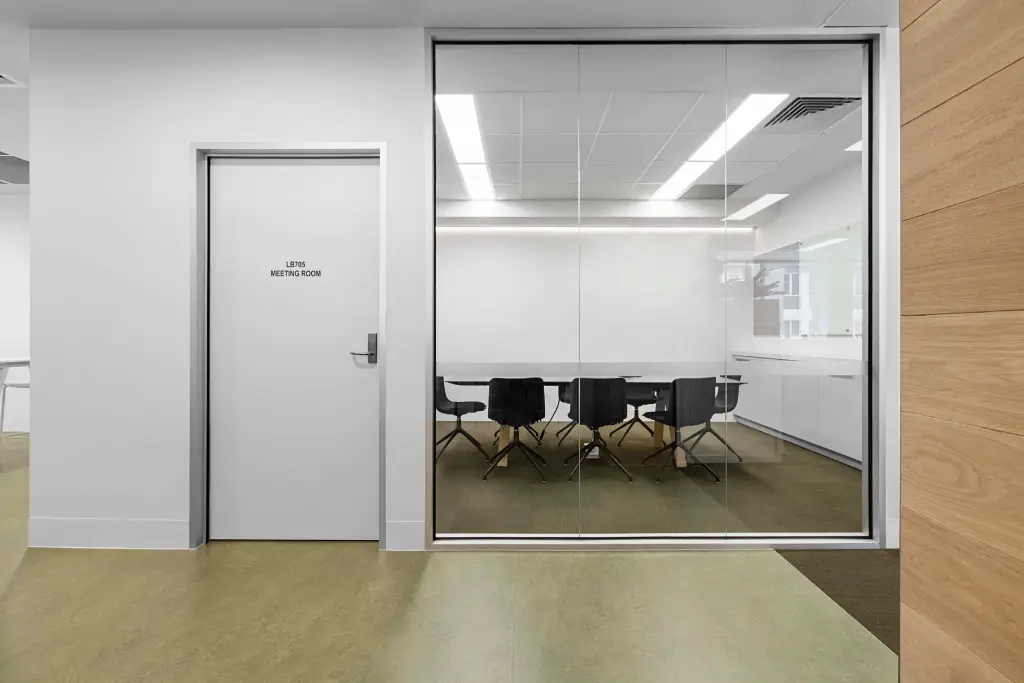 Frameless glass office partitions dividing a corporate workspace in Altona VIC 