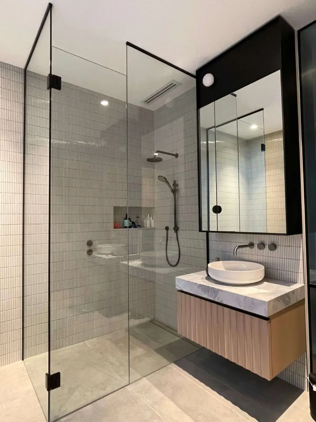 Modern frameless glass shower screen installed in a Newport residential bathroom