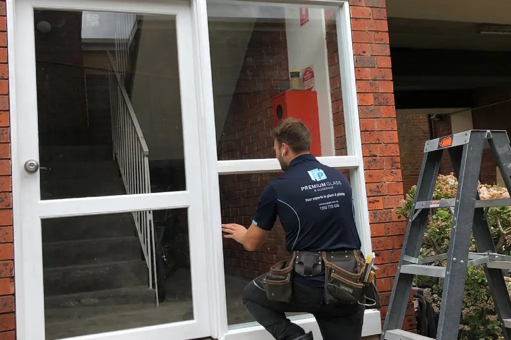 Glazier replacing a broken glass door in a Melbourne property