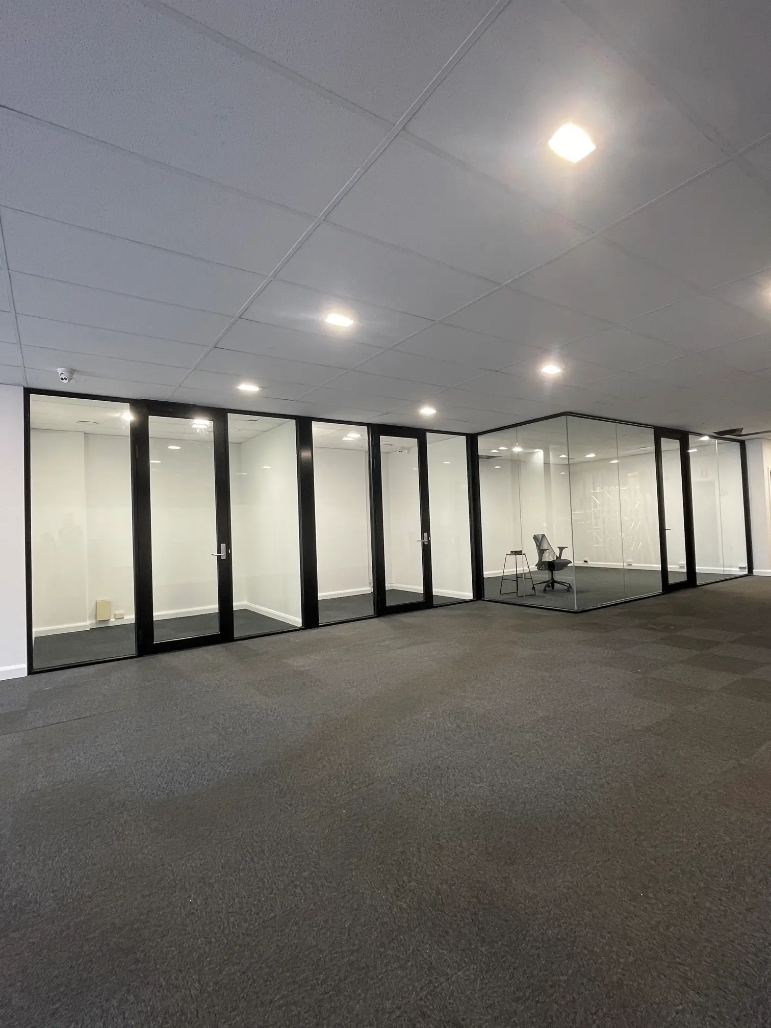 Frameless glass office partitions used to create a clean and modern office layout