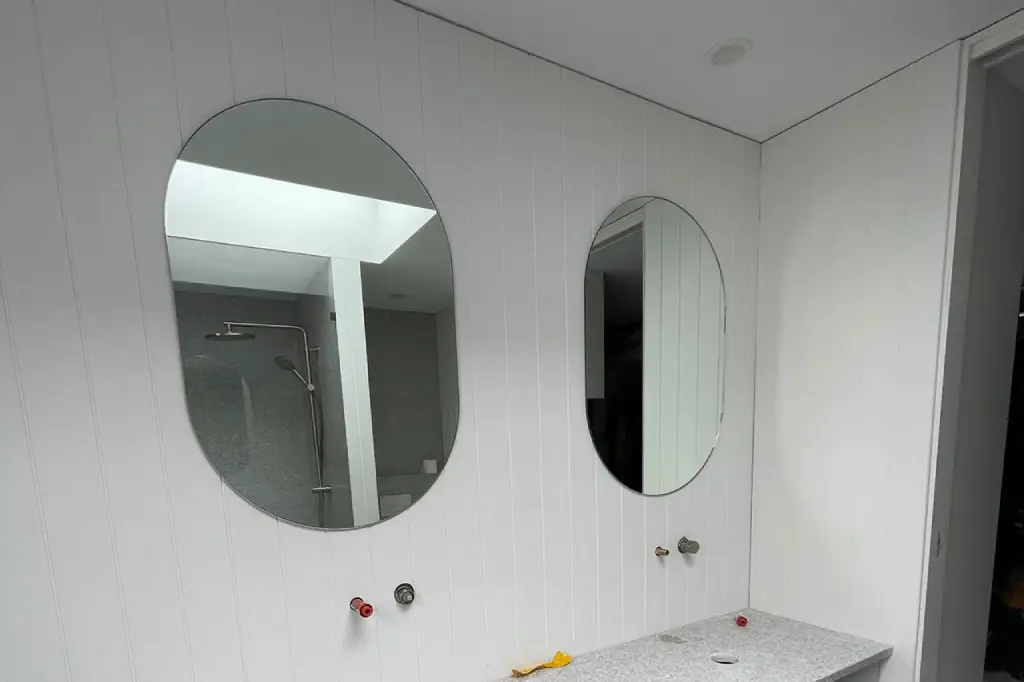 Double custom mirror made with high-quality materials, installed in a bright interior space