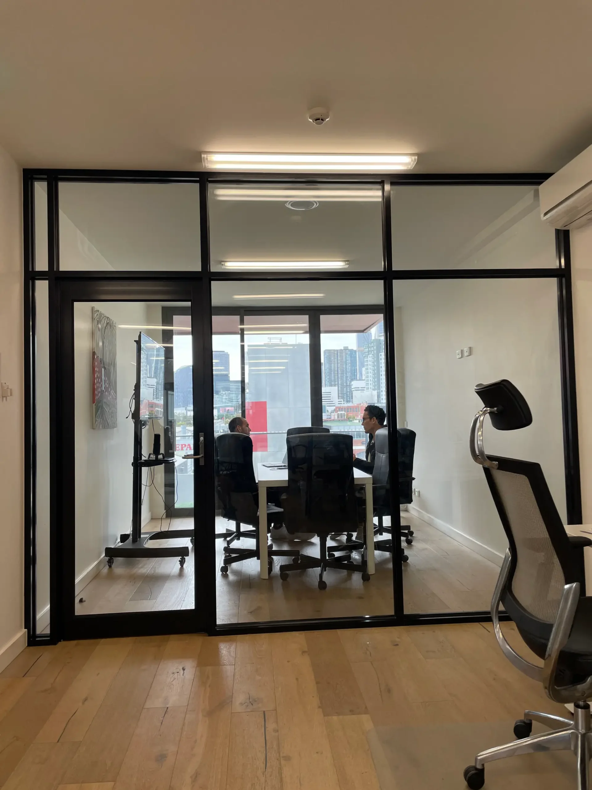 Installed office glass partitions separating workstations in a professional setting