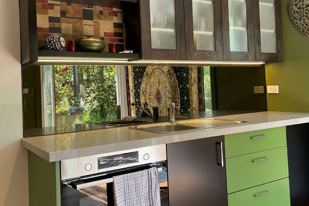 Long-lasting glass splashback installed behind a cooktop in a modern kitchen