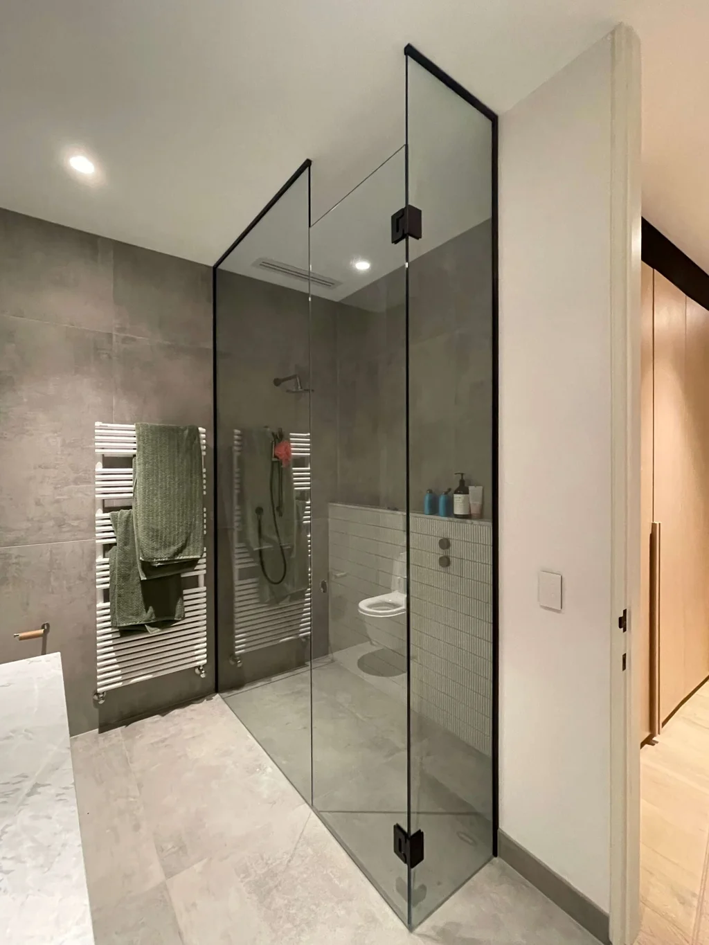 Custom glass shower screen in a modern residential bathroom in St Kilda 